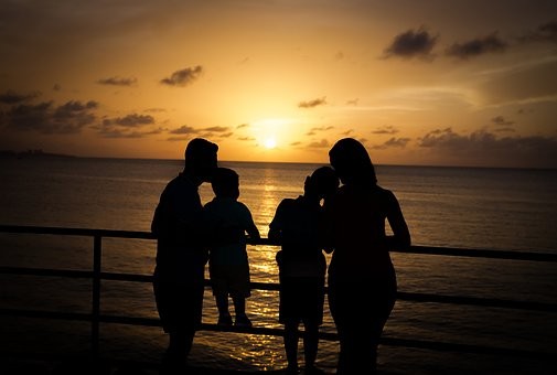 A family of four looking at the sunset